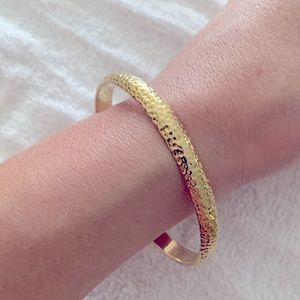 Gold tone bangle bracelet with hammered texture
